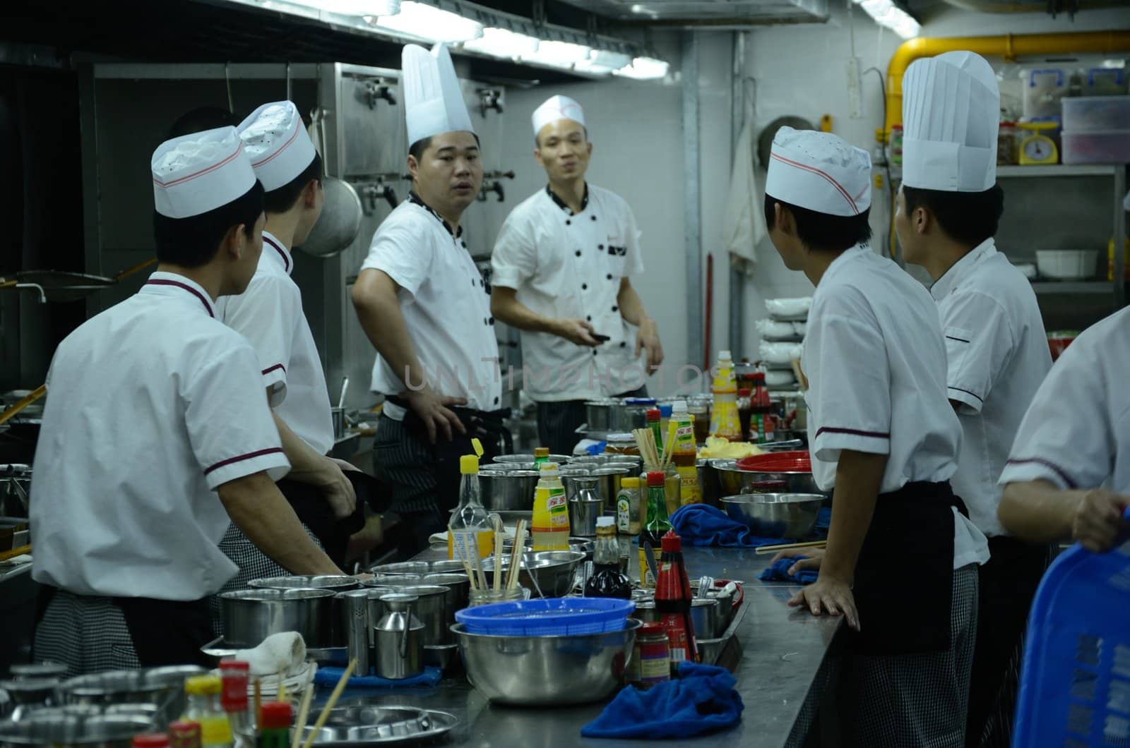 SHENZHEN, CHINA - SEPTEMBER 8: Unidentified Chinese chefs work in kitchen, inside Cantonese style restaurant in Nanshan district on September 8, 2012.