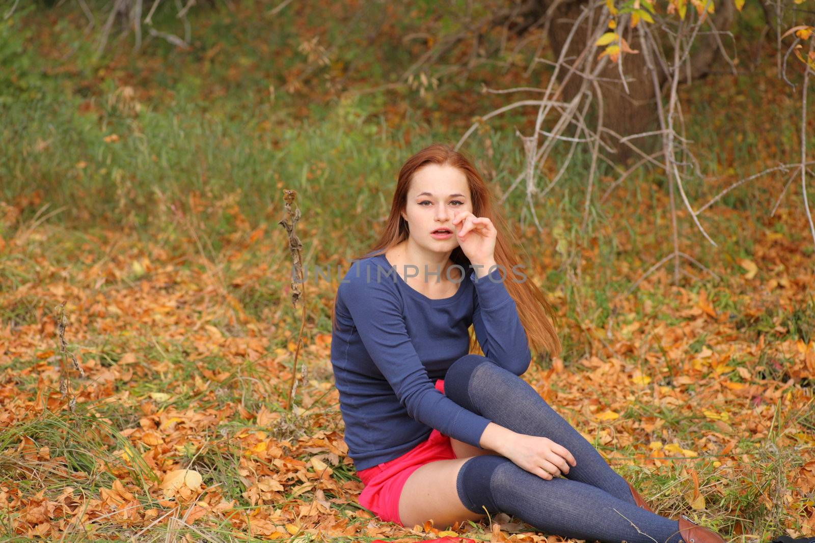 romantic girl sitting in autumn leaves by mettus