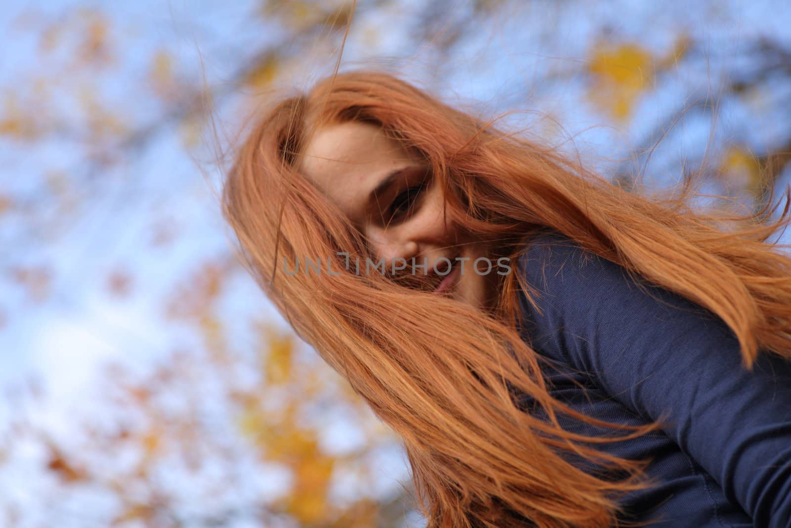 beautiful red-headed girl posing by mettus