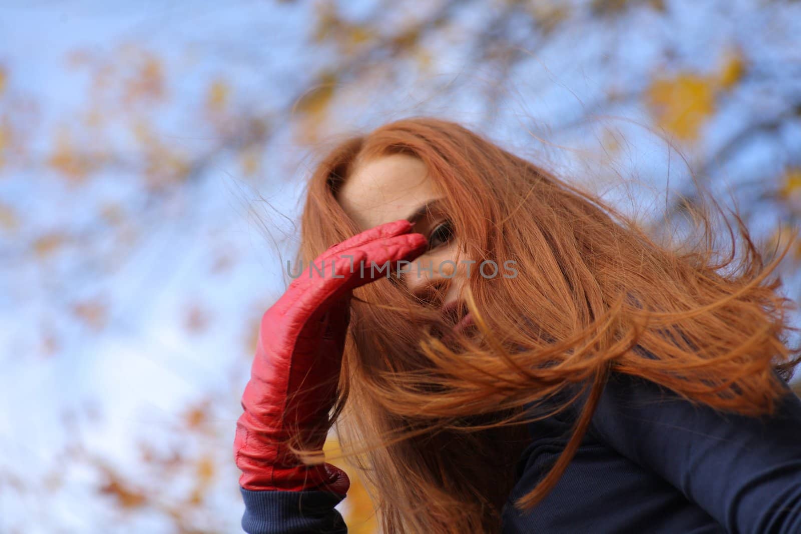 beautiful red-headed girl posing by mettus