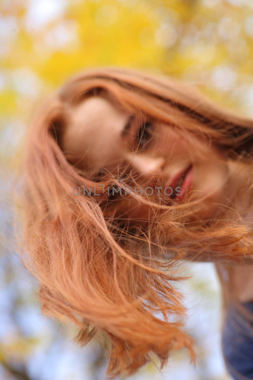 Portrait of a beautiful redhead girl smiling outdoors