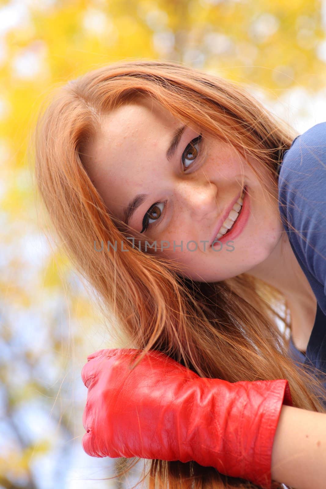 Portrait of a beautiful redhead girl smiling outdoors