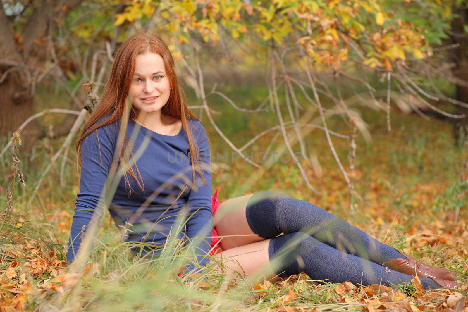 romantic girl sitting in autumn leaves by mettus