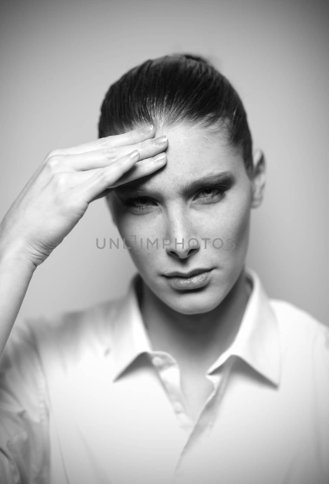 Beautiful woman having headache with hands on temple, shallow deep of field