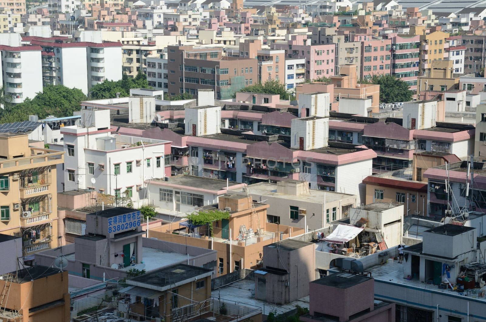 SHENZHEN, CHINA - SEPTEMBER 16:  Modern Shenzhen city, Futian district with old residential buildings on September 16, 2012. Within few years old houses will be replaced with modern skyscrapers.