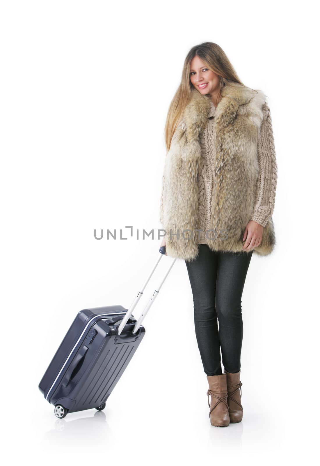 Young woman in winter clothes with a rolling suitcase.