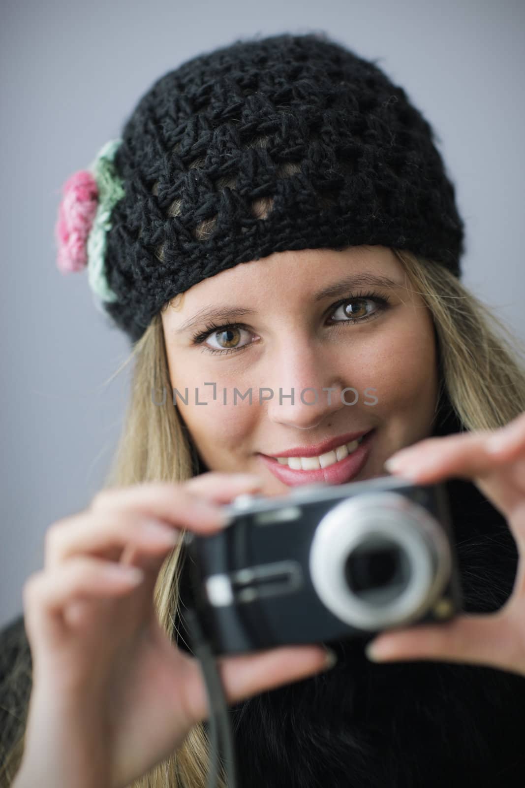Young woman taking a picture with digital camera