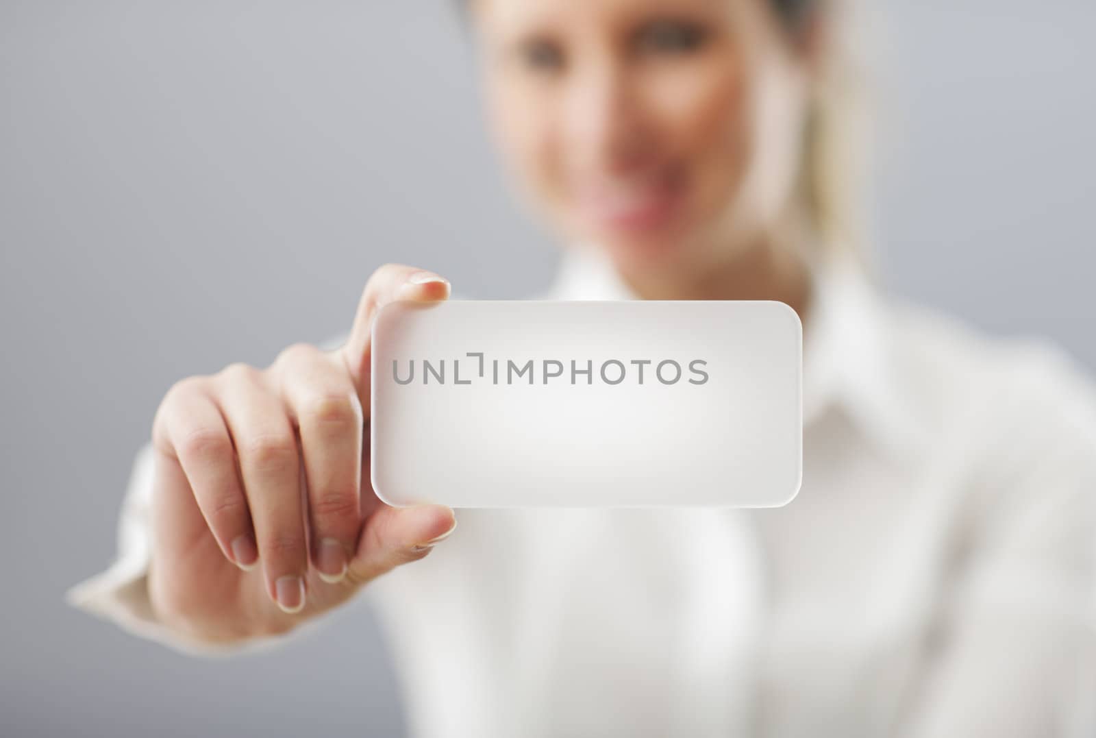 Businesswoman showing his business card. Shallow depth of field - focus on fingers and card. You can just add your text there.