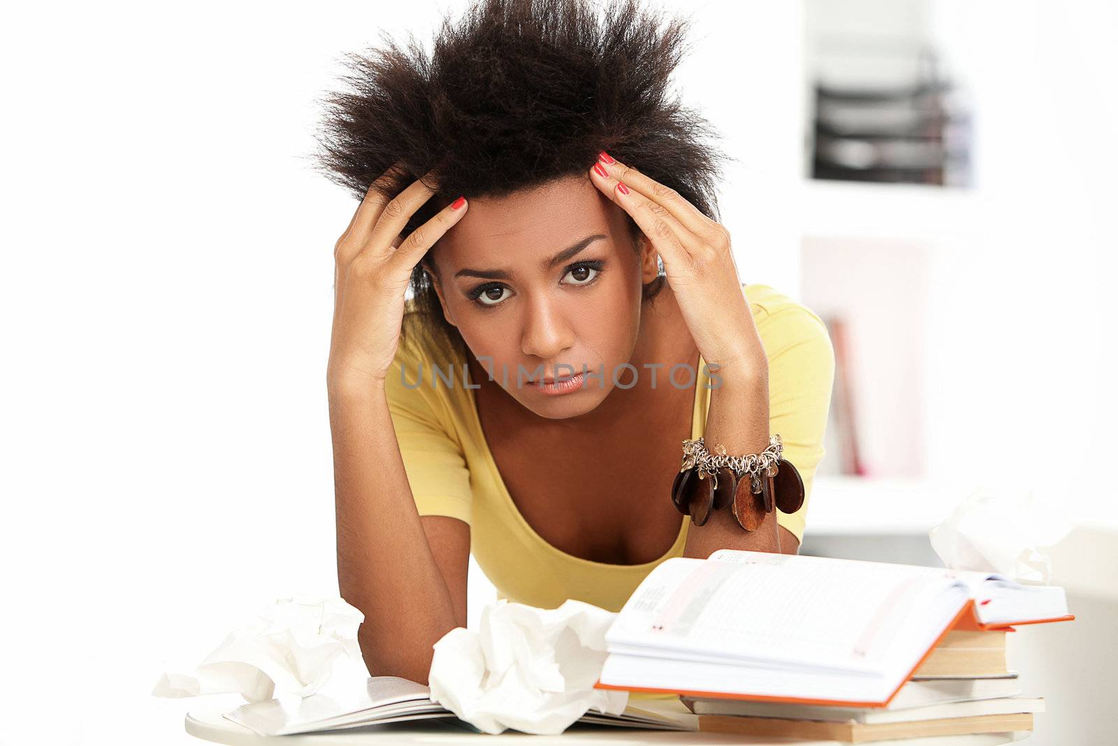 Young black woman tired from studying with books