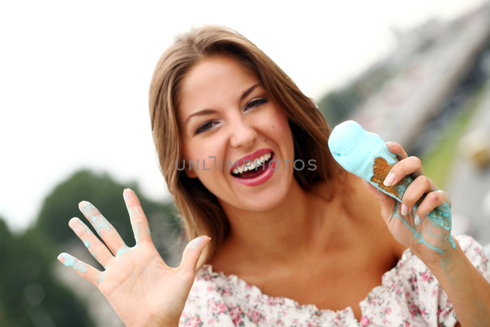 Young and attractive girl eating icecream on a street