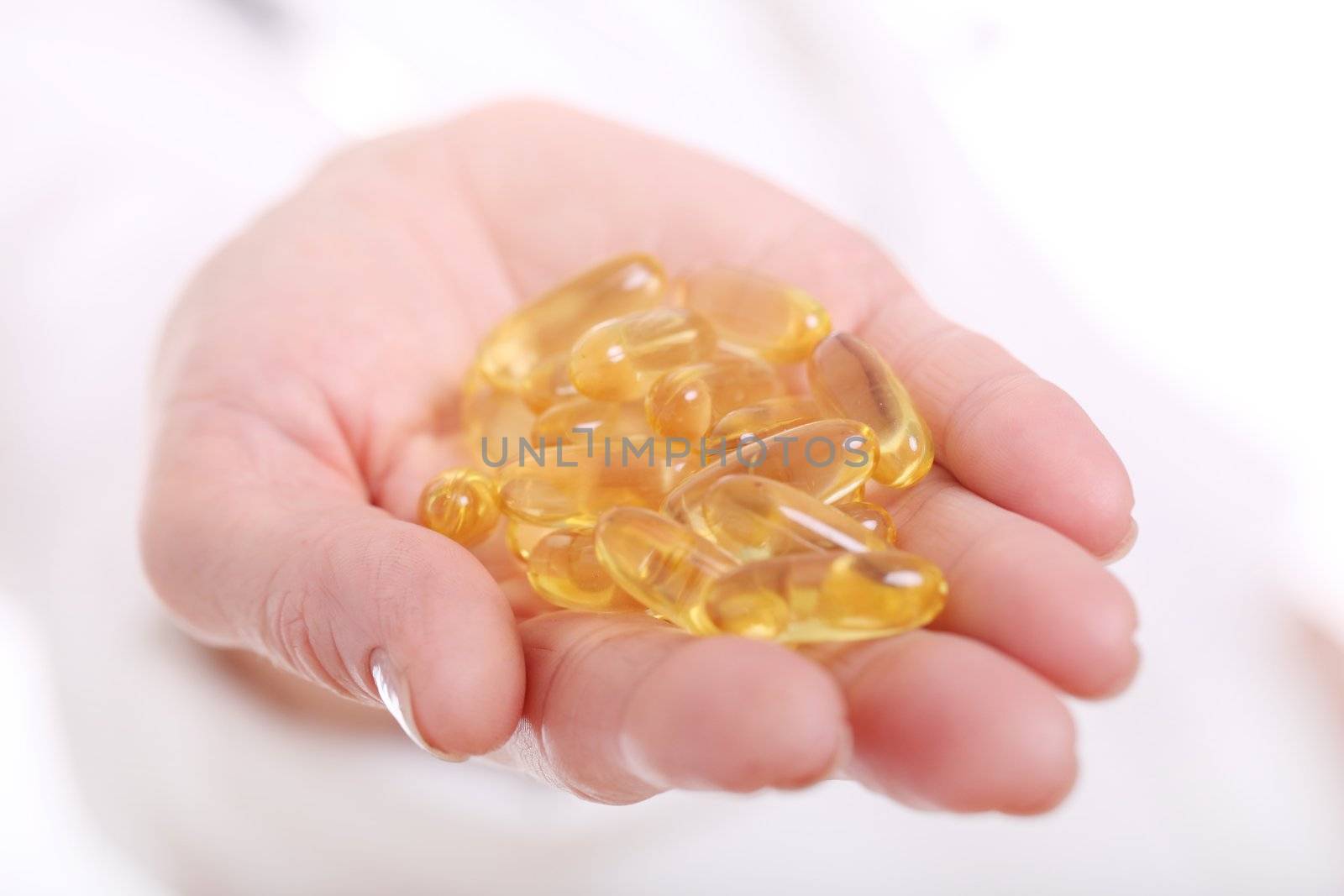 Close up of doc hand holding pills isolated on a white