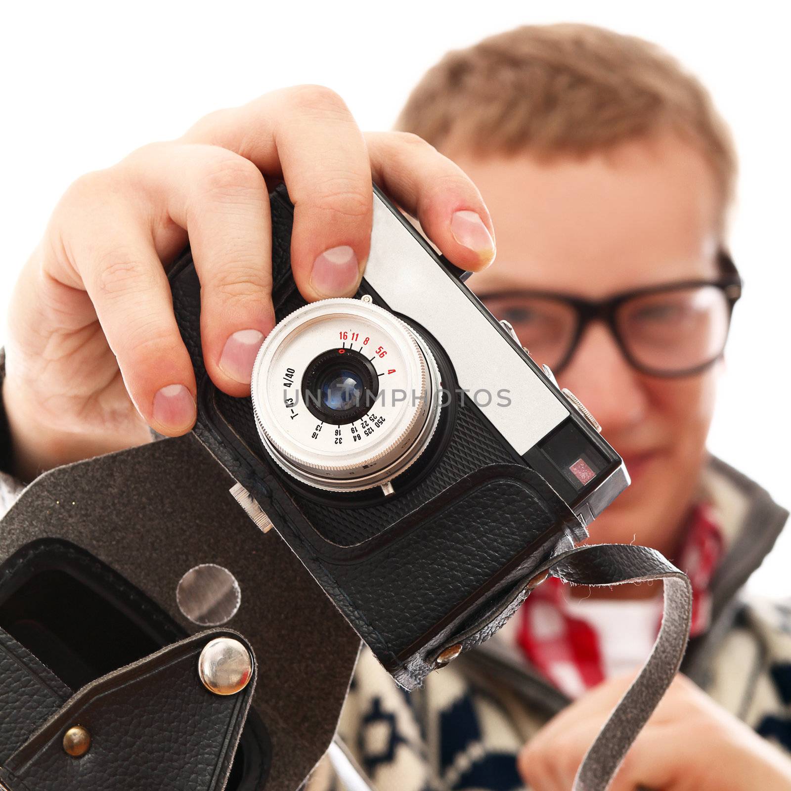 Young photographer with old camera make a photo shoot of you isolated on a white