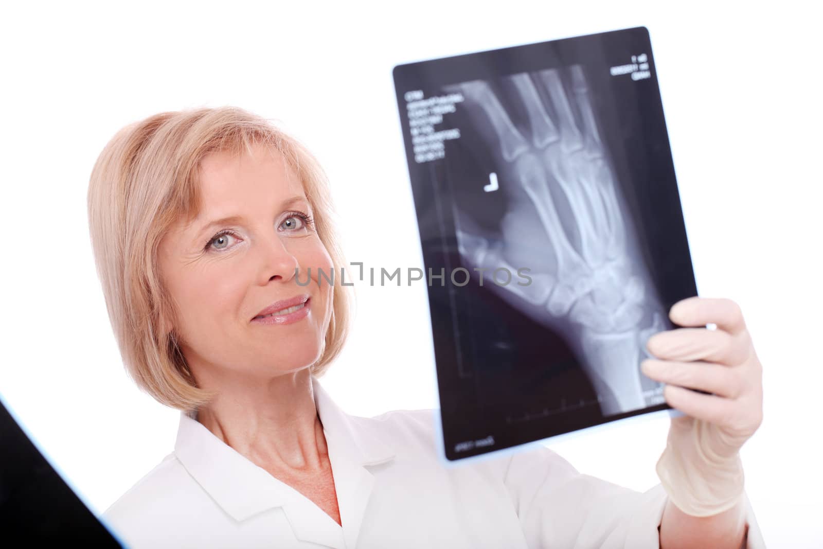 Female doctor looking at an x-ray over a white background