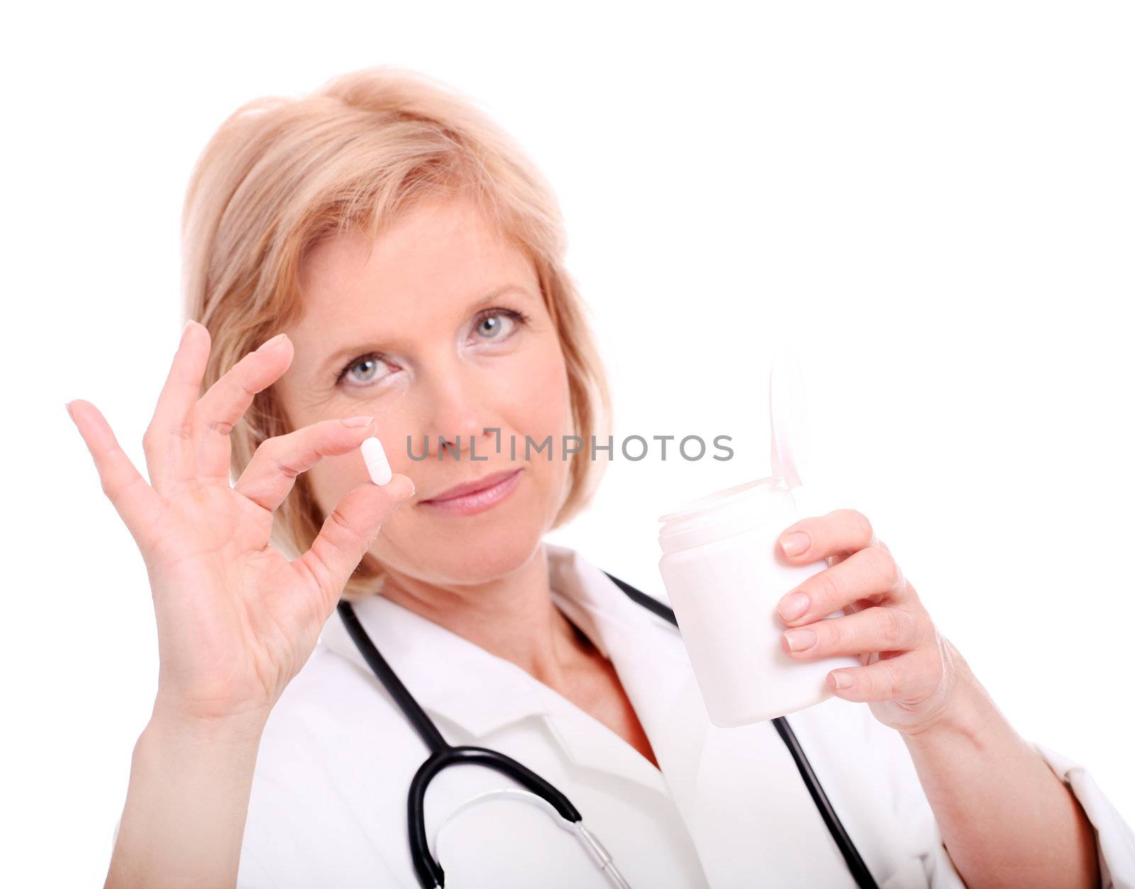 Female doctor holding a pill and glass isolated on a white