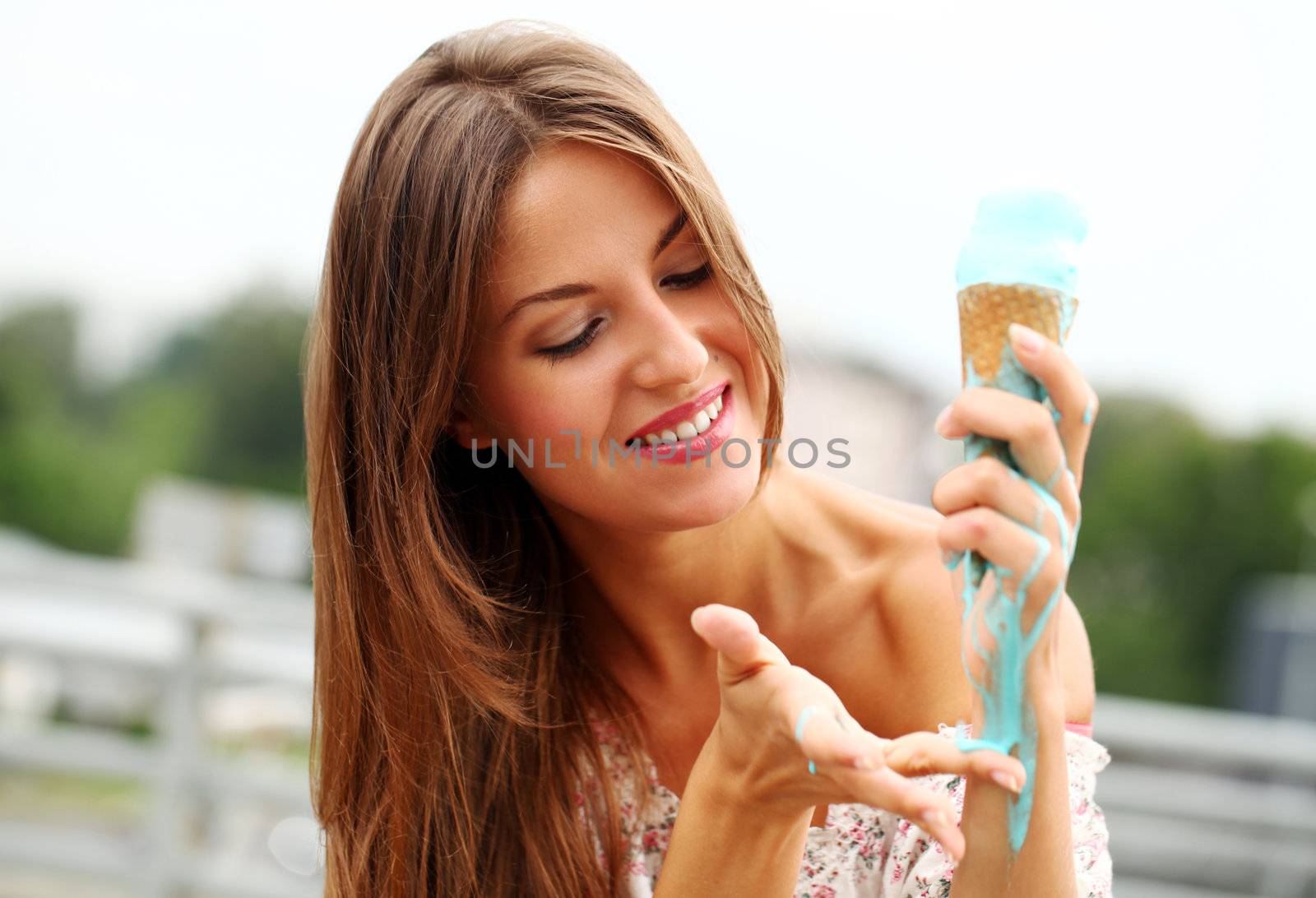 Young and attractive girl eating icecream on a street