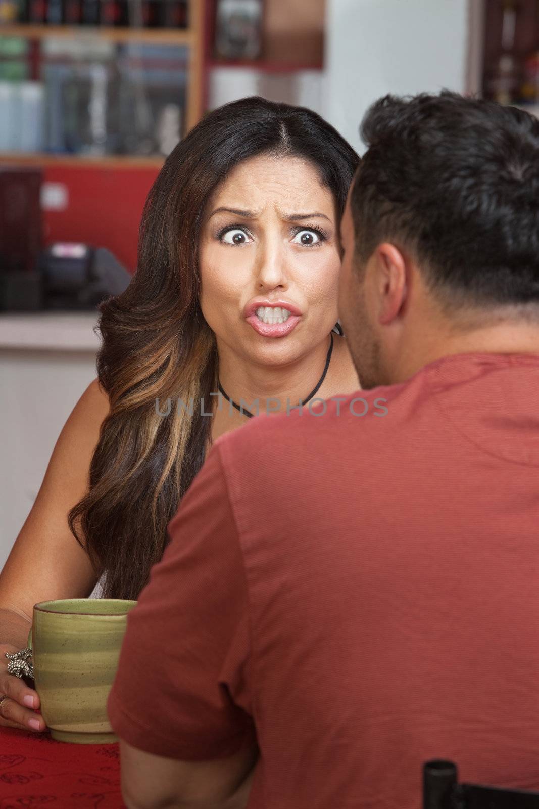 Furious woman yelling at man in restaurant