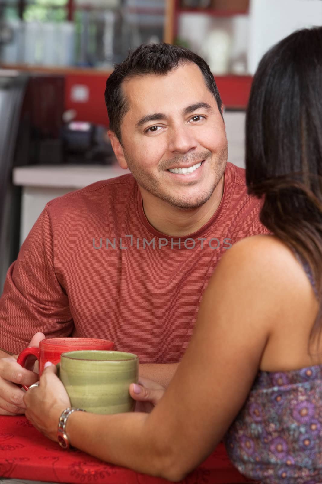 Smiling handsome hispanic man with woman in coffeehouse