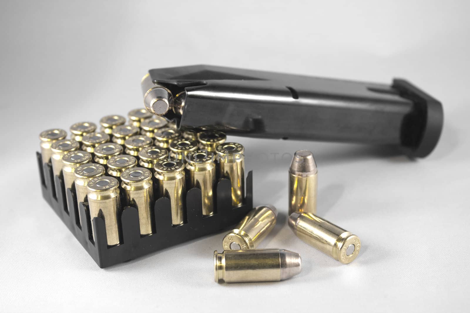 Handgun clip and bullets isolated on a white background