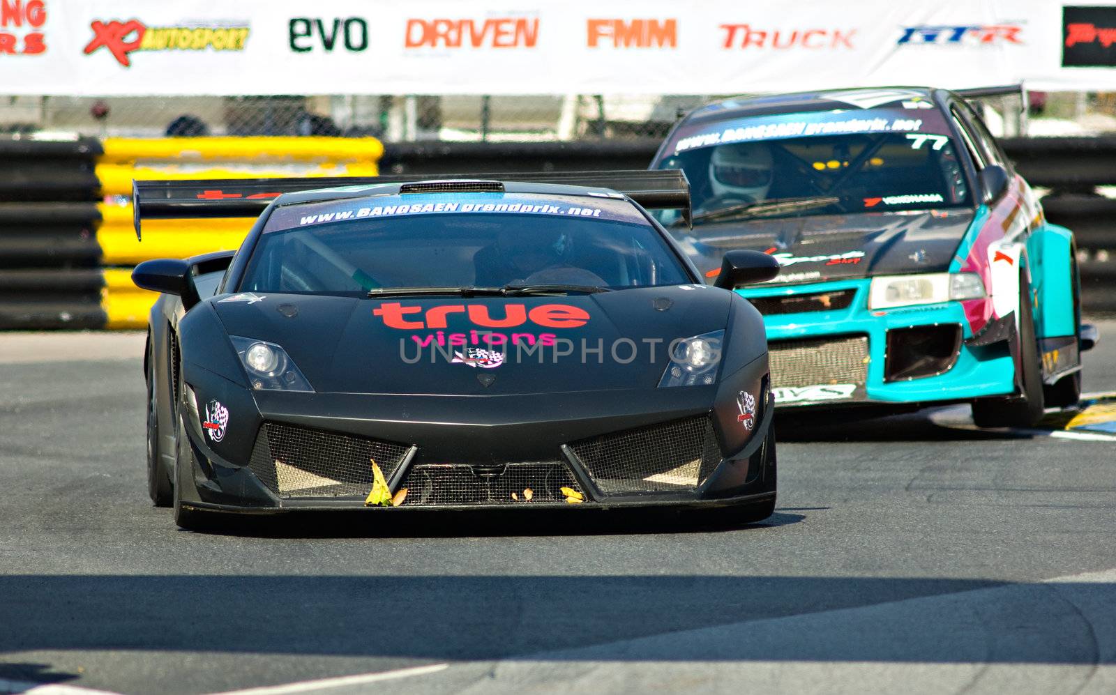 BANG SAEN - DECEMBER 22: Car 78, a black Lamborghini Gallardo, with number 77, the Mitsubishi EVO VI of Krann Suppapong following behind, during the 2012 Bang Saen Speed Festival in Thailand on December 22, 2012.