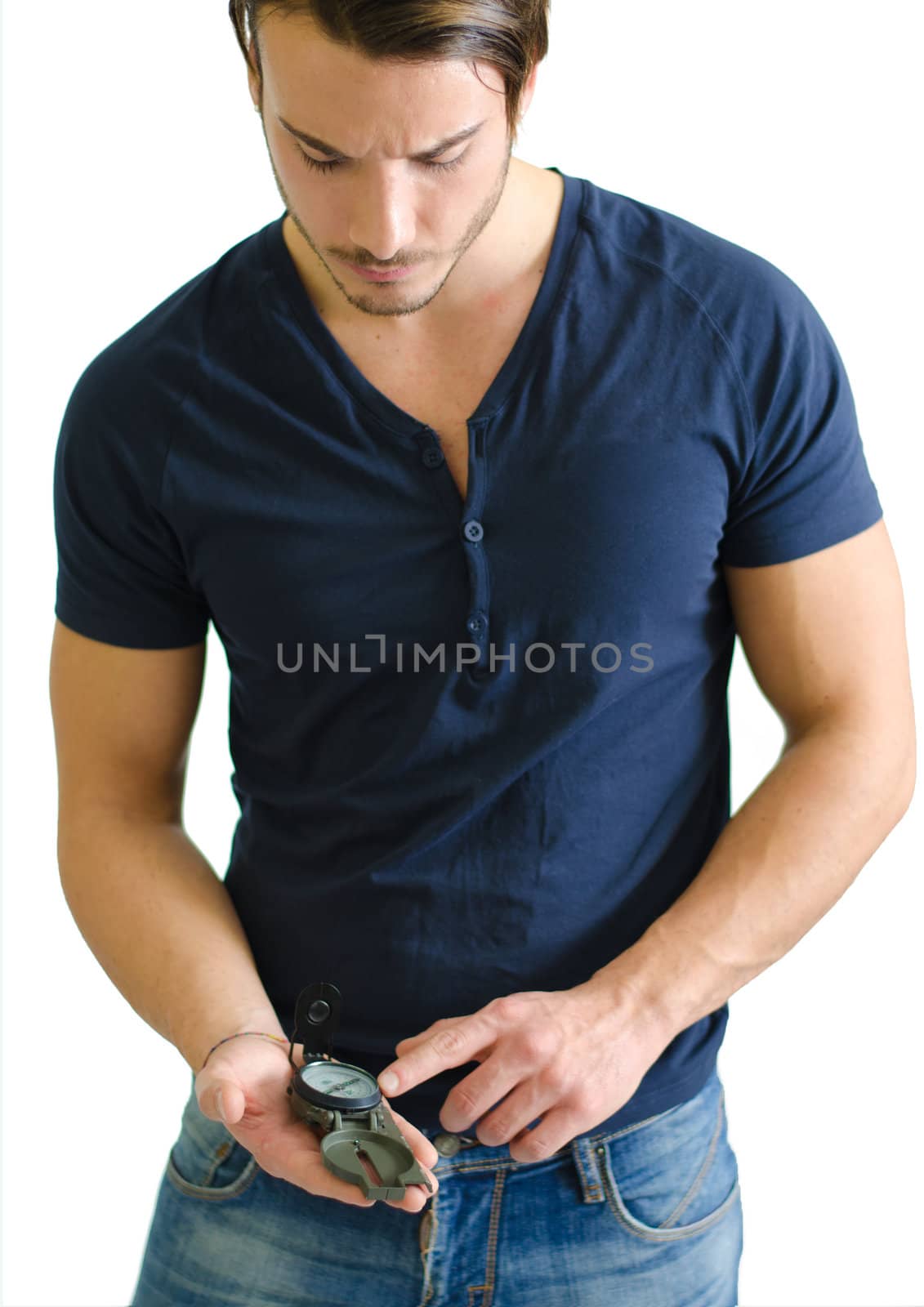 Attractive young man standing with compass in his hand by artofphoto