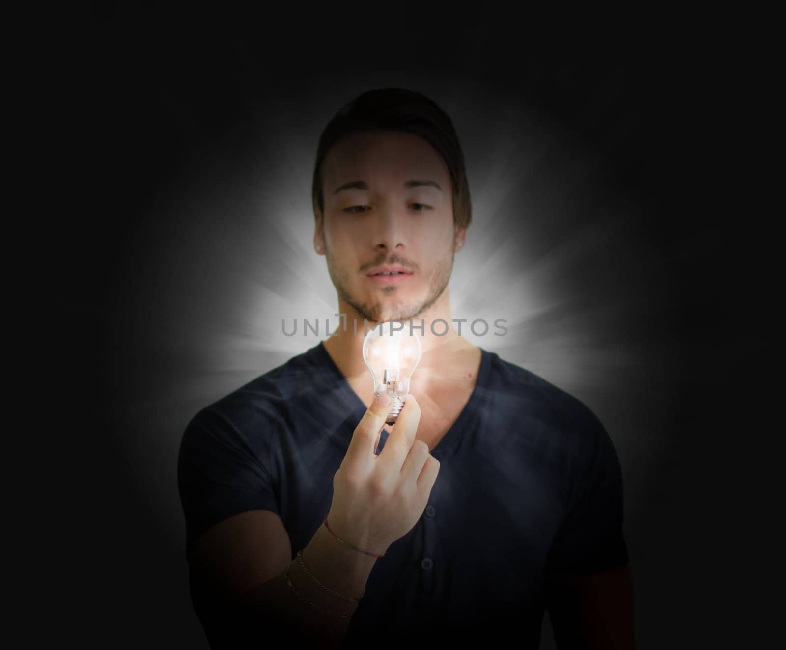 Young man looking at lit up lightbulb. Idea, enlightment concept
