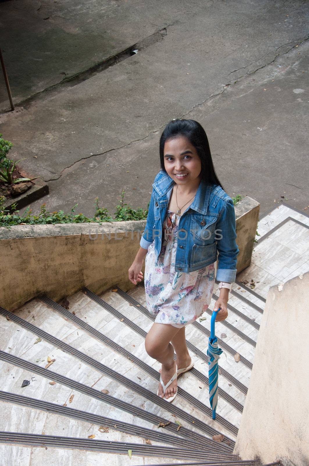 healthy asian woman portrait walking up on staircase