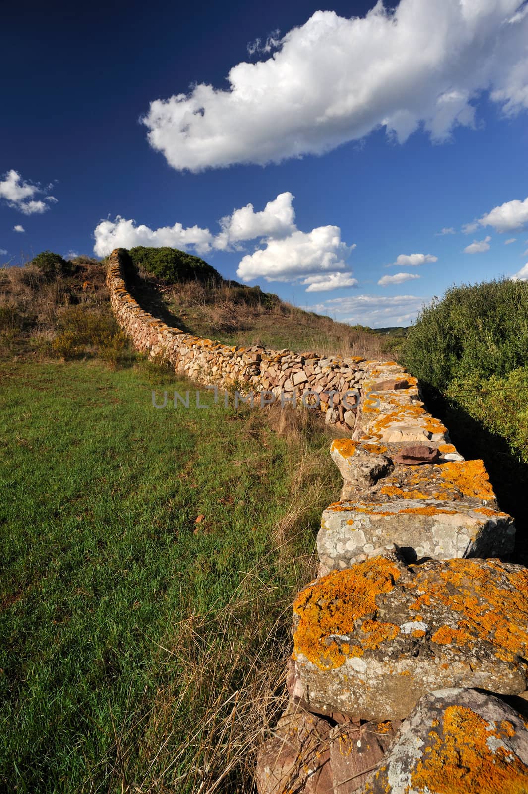 Landscape with an ancient stone wall by stokkete