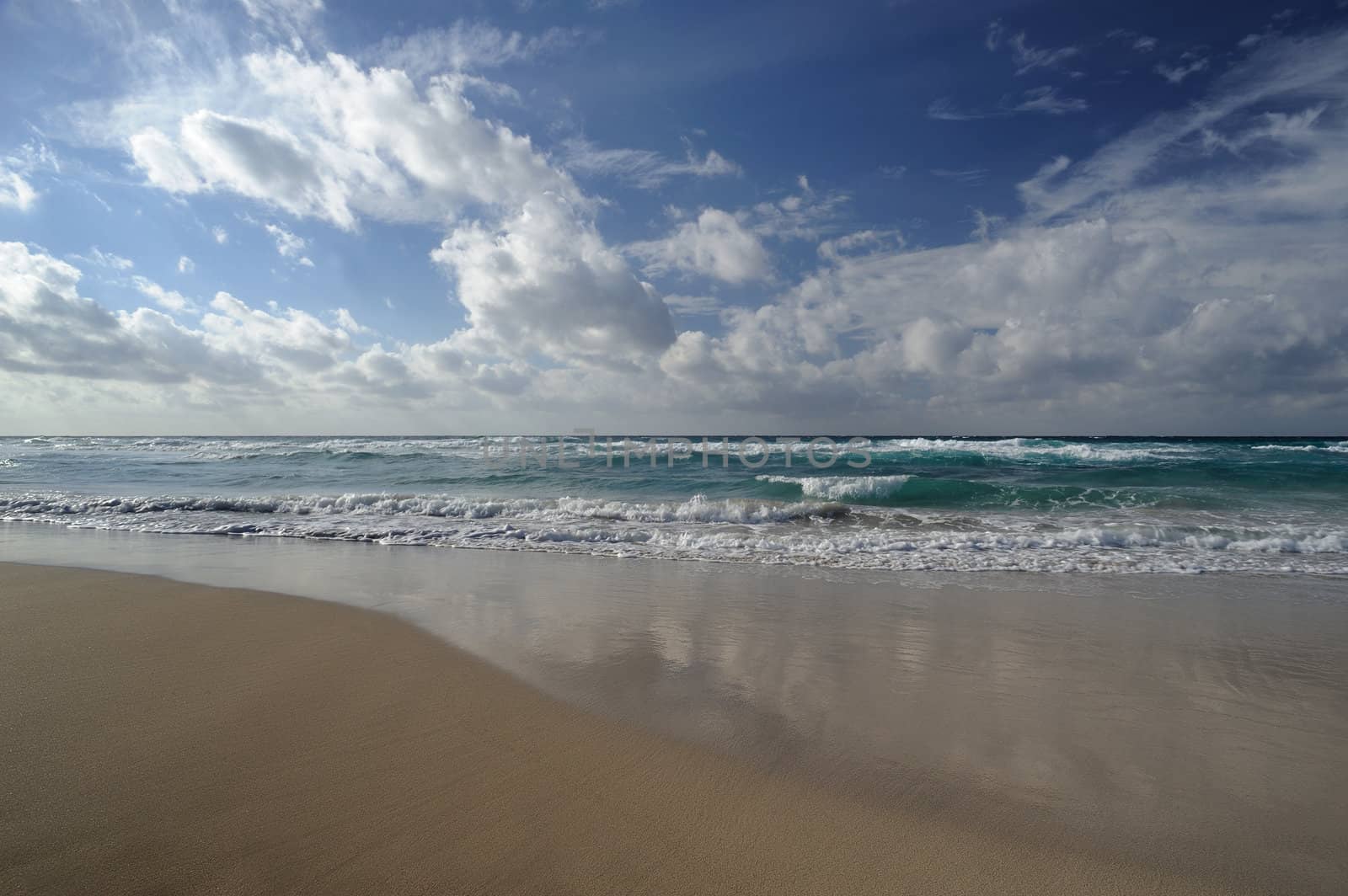 Landscape with sea and sand, white clouds in the sky