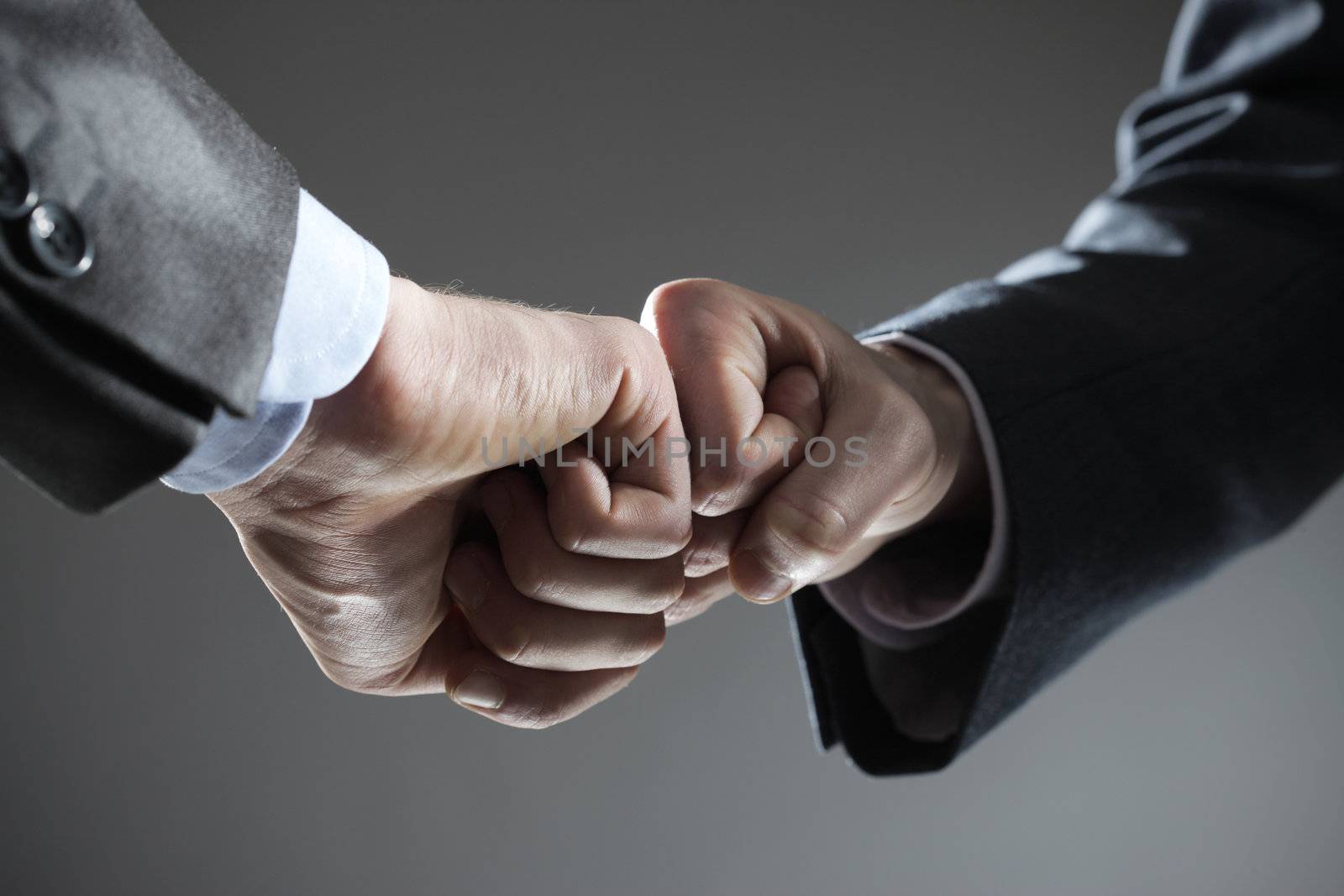 Business teamwork: two fists touching hand gesture