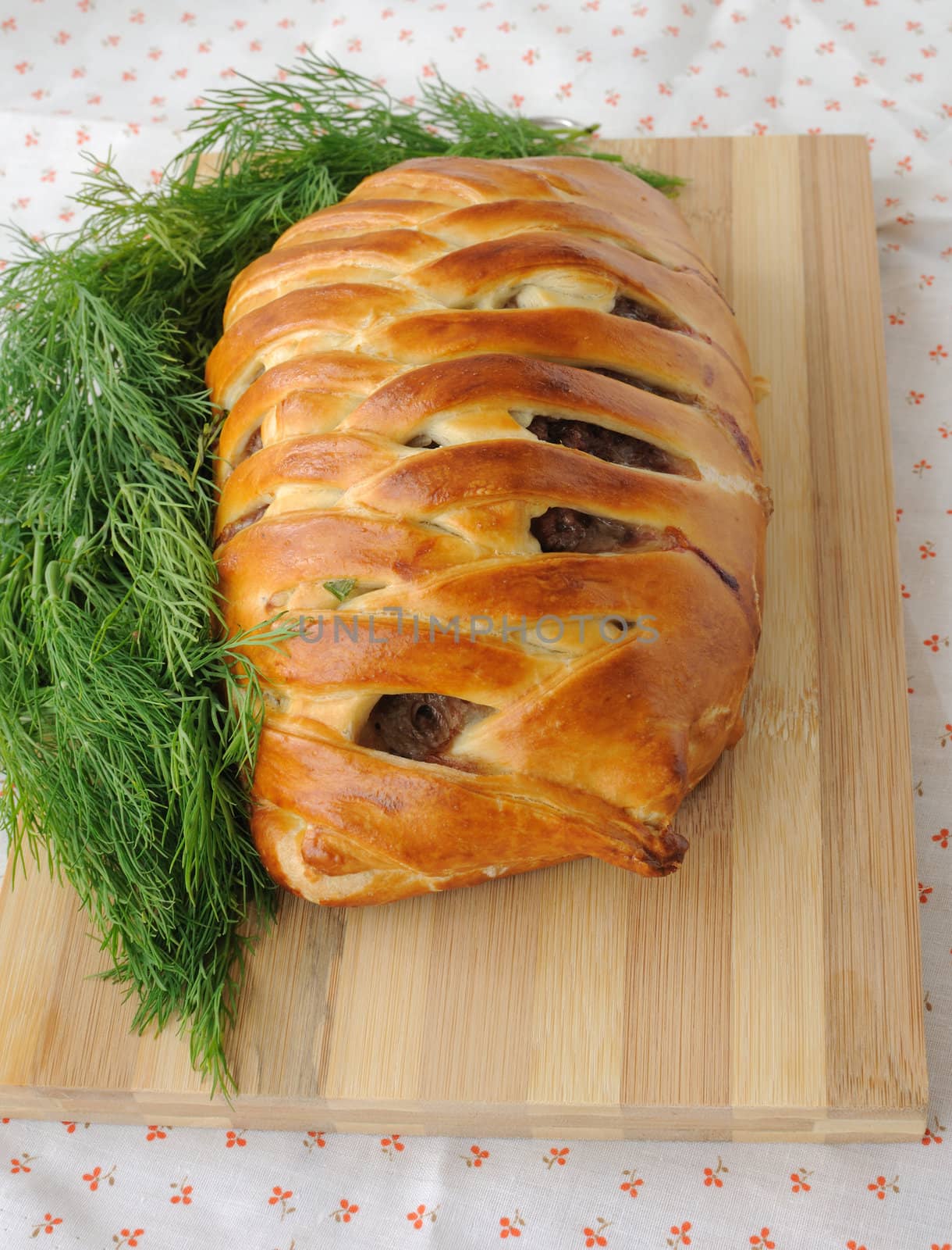 Meat loaf with egg and greens in the test a wooden board