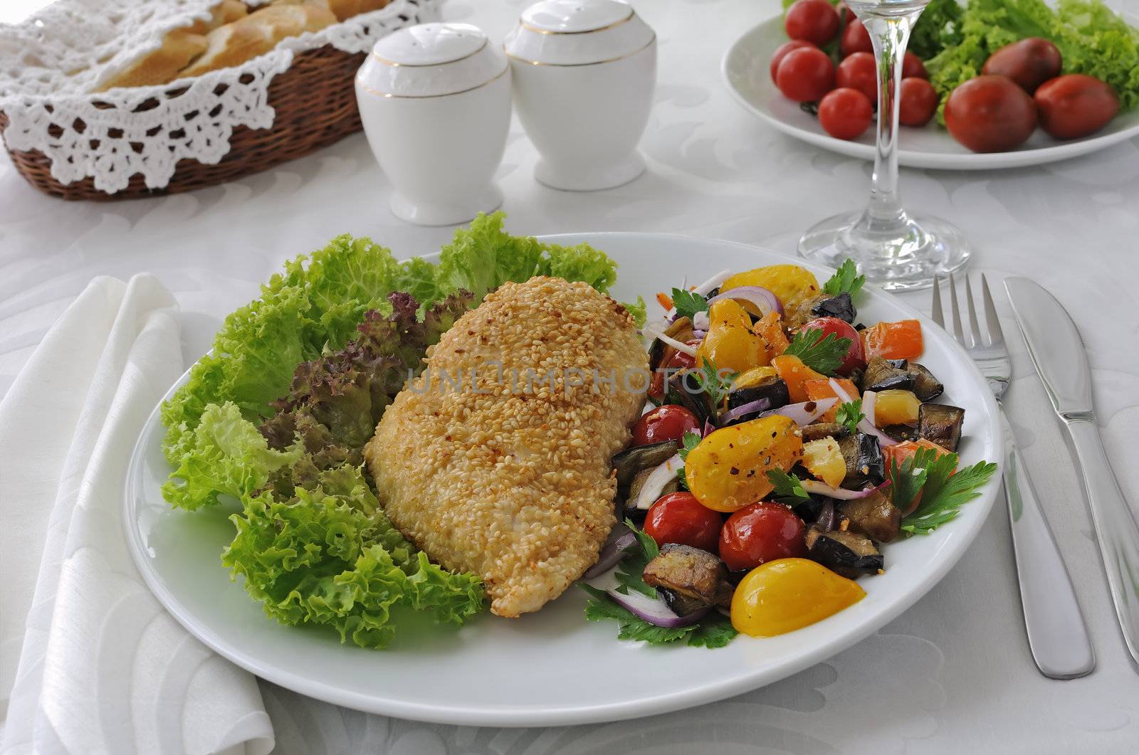 Chicken schnitzel with sesame with eggplant, tomato and pepper