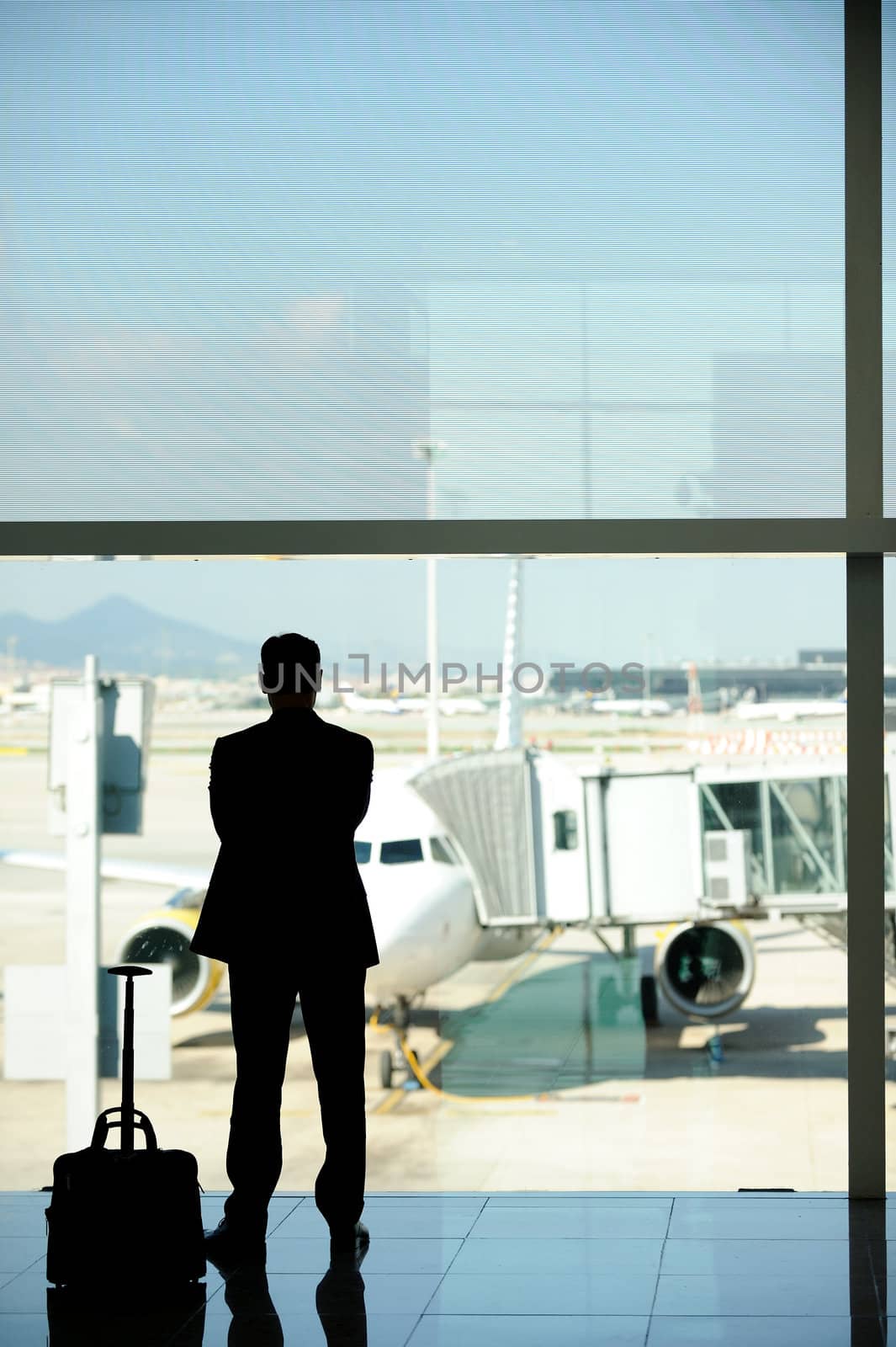Business man at the airport, waiting for his airliner
