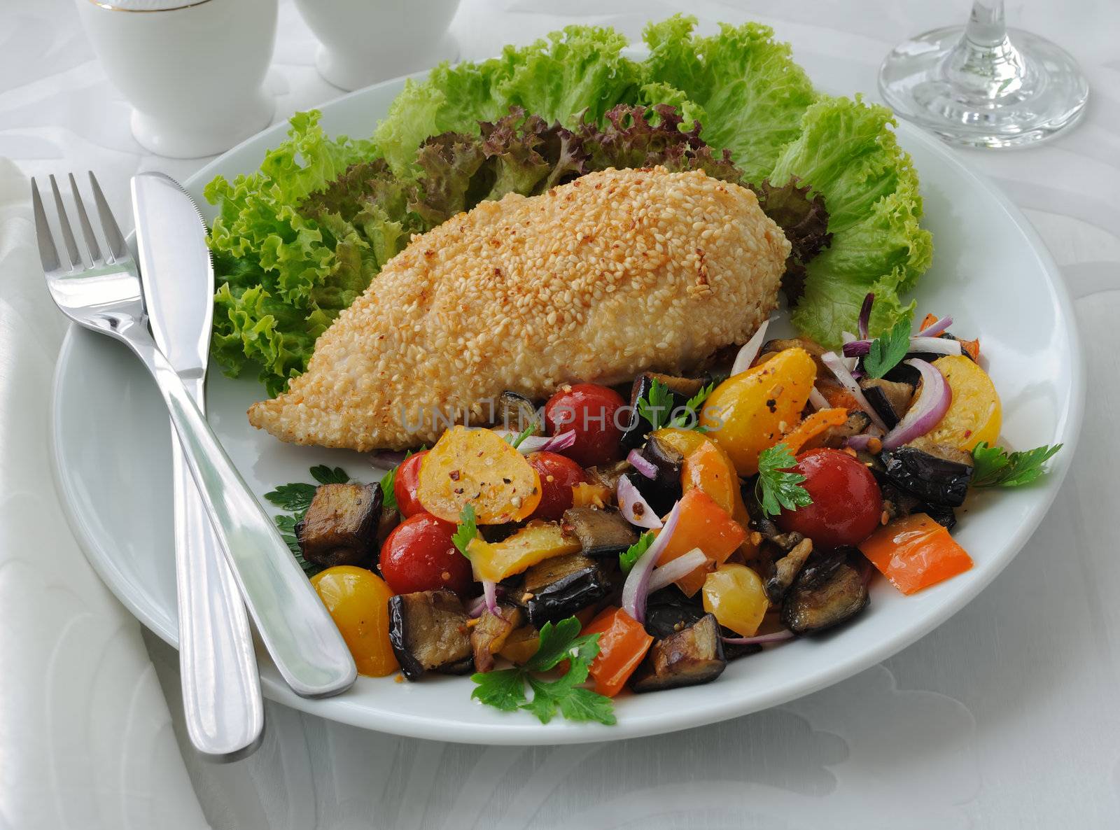 Chicken schnitzel with sesame with eggplant, tomato and pepper