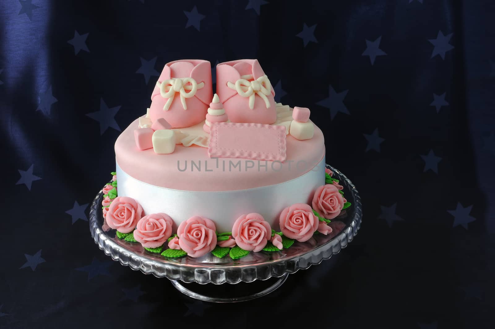 Cake with booties and toys made of marzipan