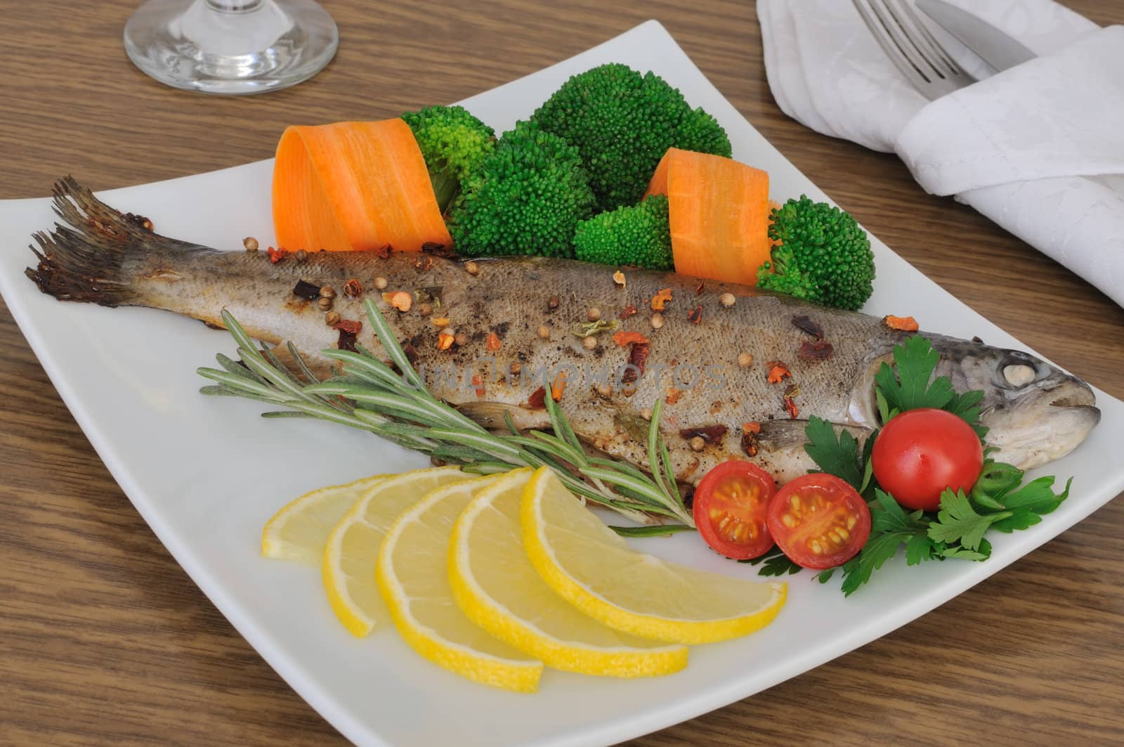Baked sea bass in spices with broccoli and carrots