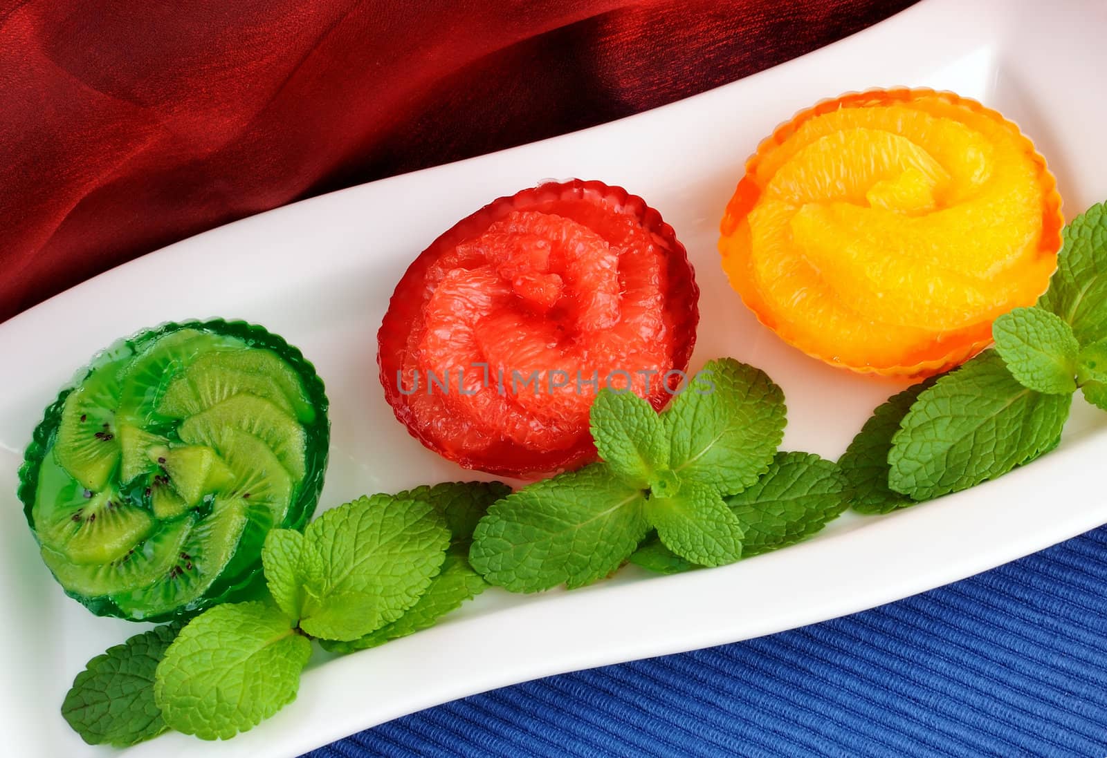 Jelly dessert of fresh fruit (oranges, grapefruit, kiwi) with mint