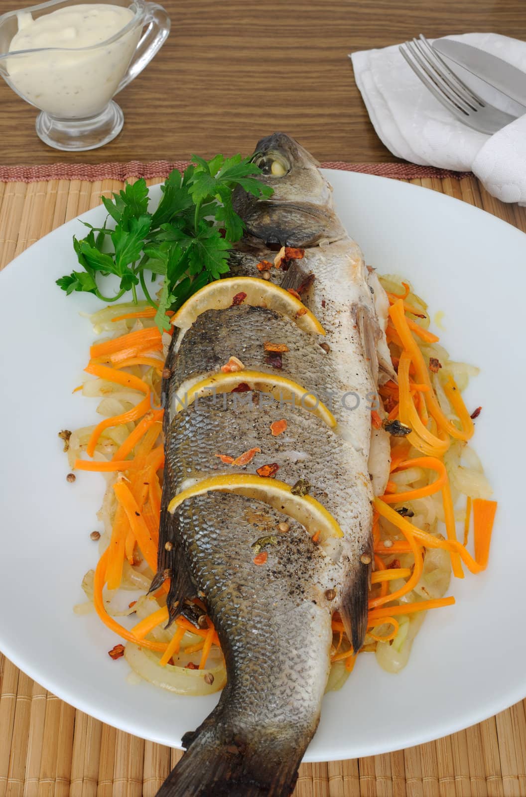 Baked trout with lemon onion and carrot on a pillow
