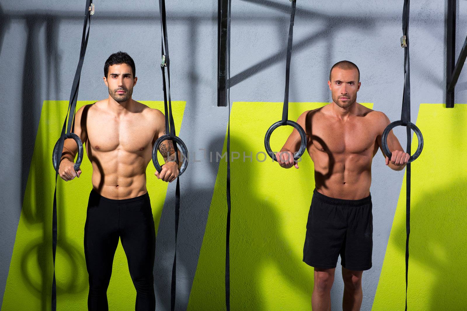 Crossfit dip ring two men workout at gym dipping exercise