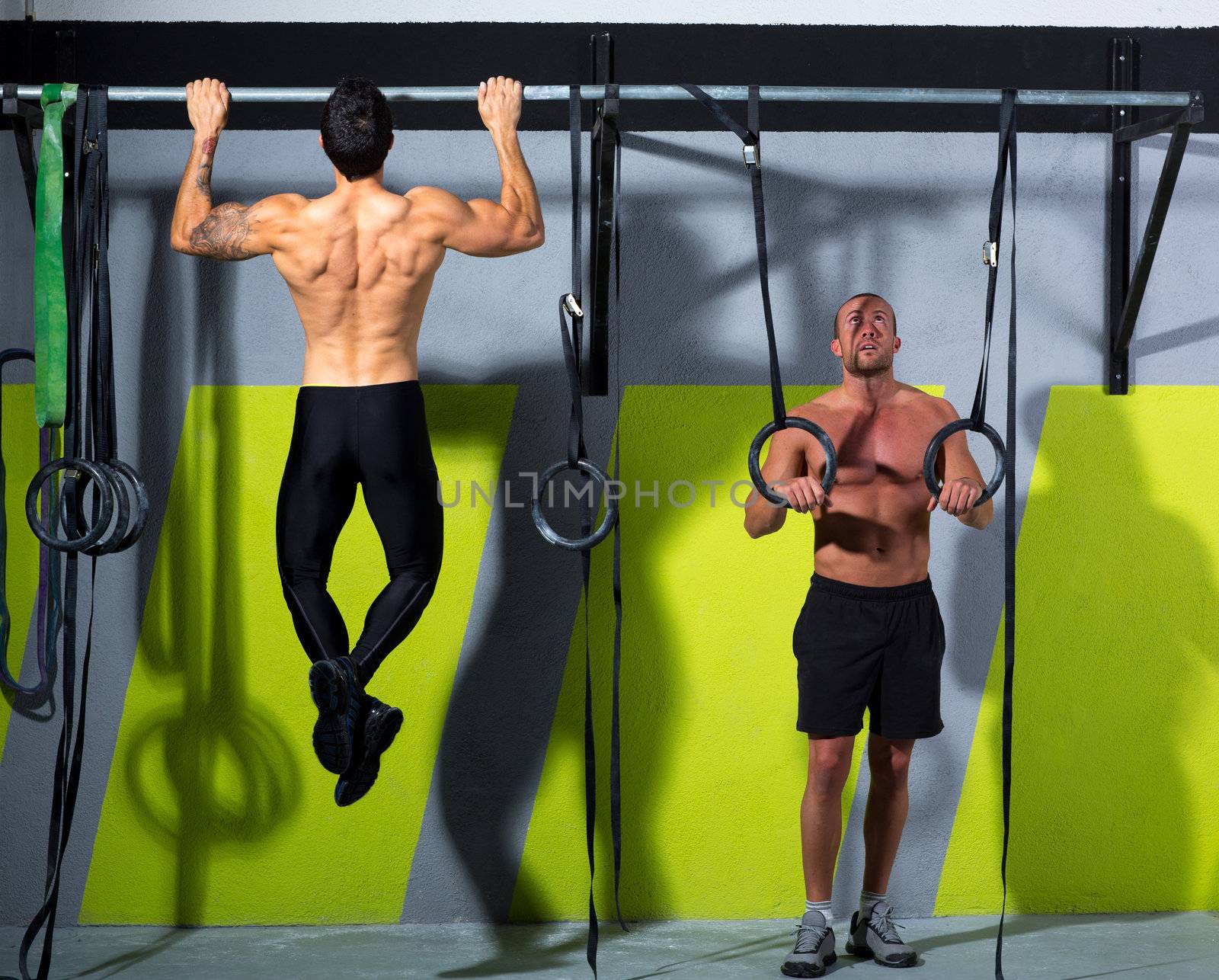 Crossfit dip ring and toes to bar man pull-ups men workout at gym