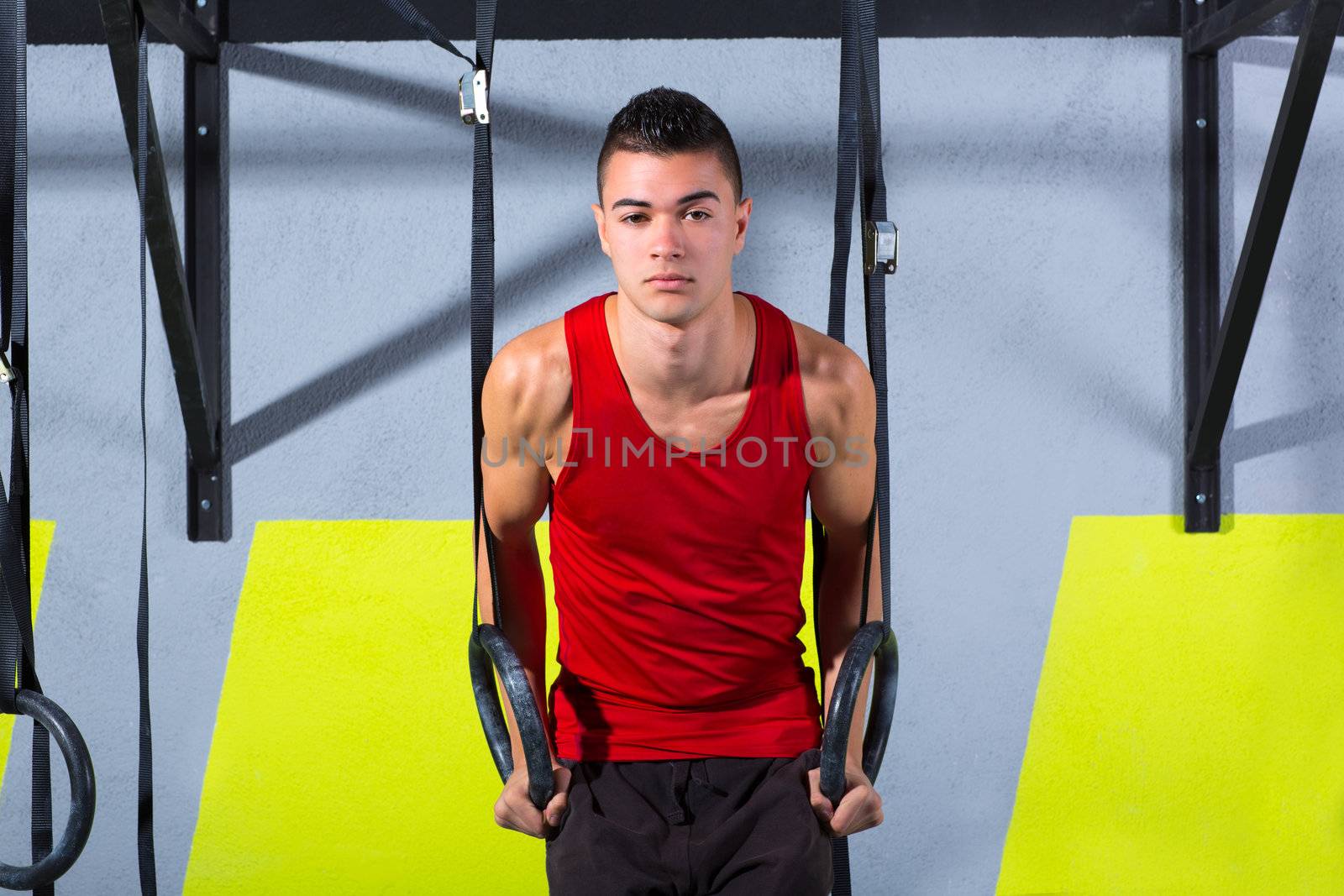 Crossfit dip ring young man workout at gym dipping exercise