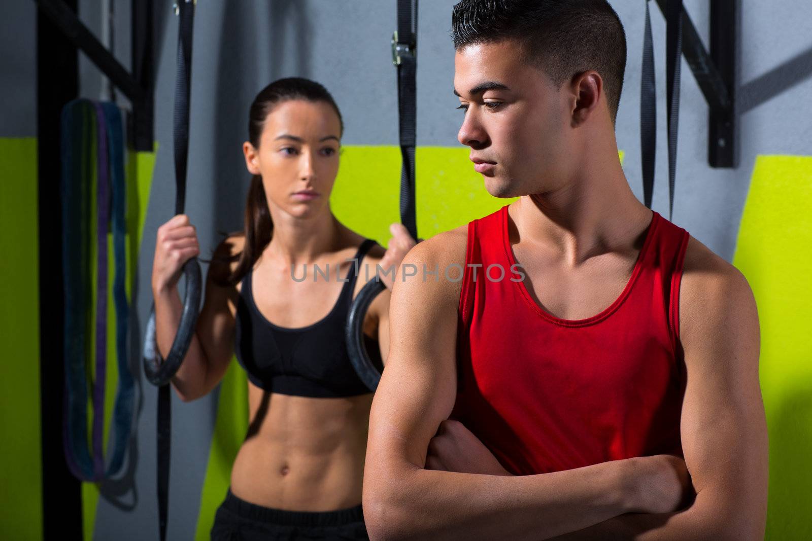 Crossfit dip ring man and woman relaxed after workout at gym dipping exercise