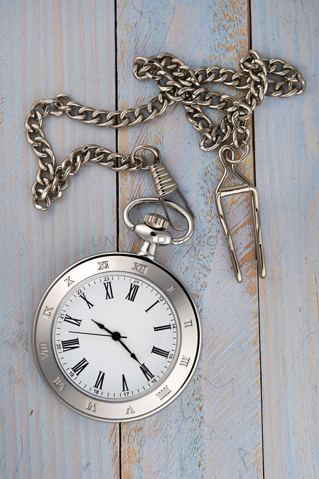 Vintage pocket watch with chain on table by kirs-ua