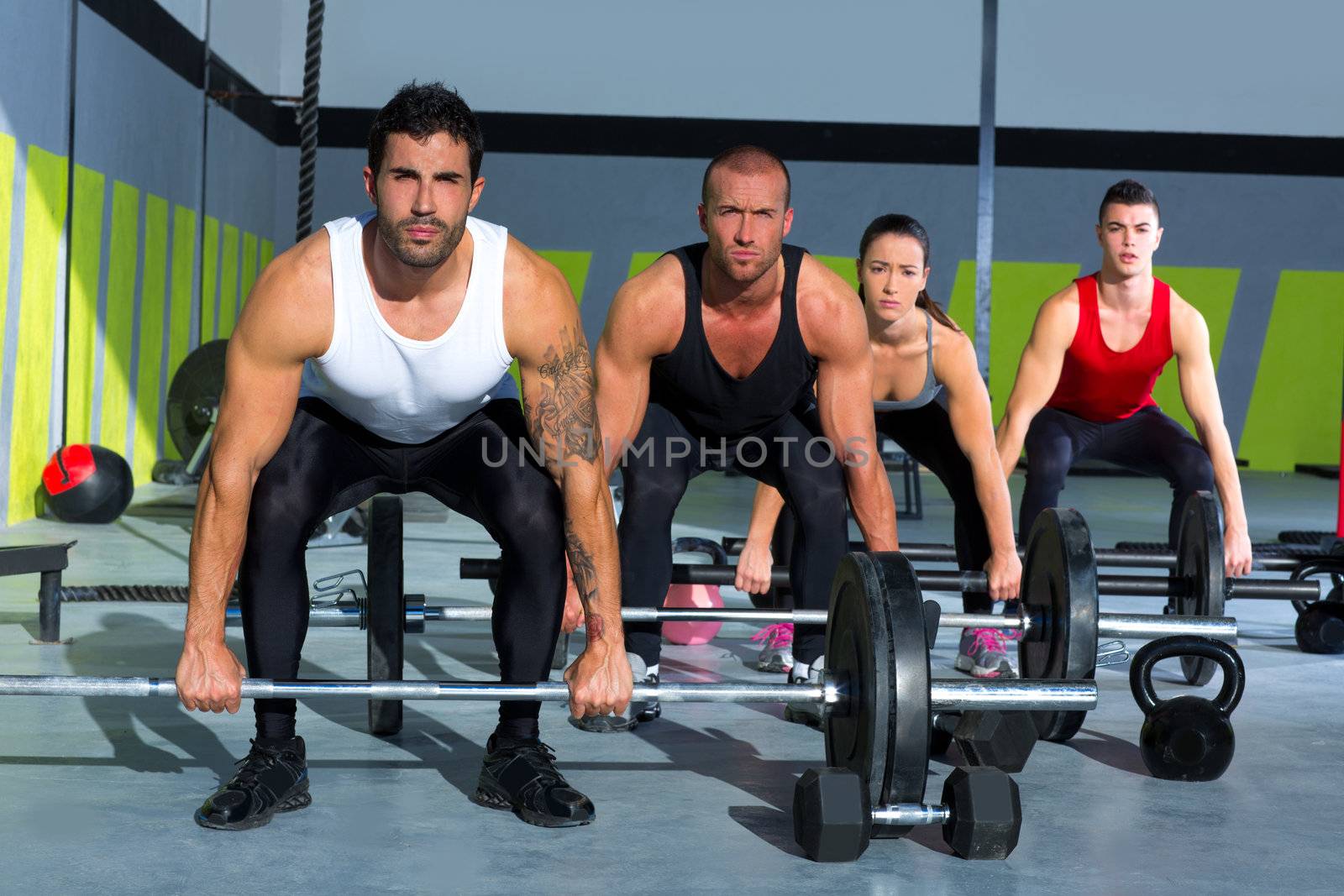 gym group with weight lifting bar workout in crossfit exercise