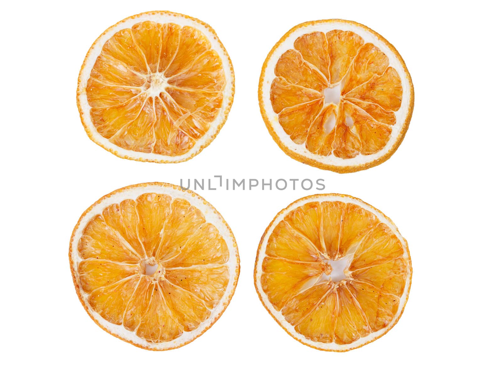 four dried slices of orange isolated on white background