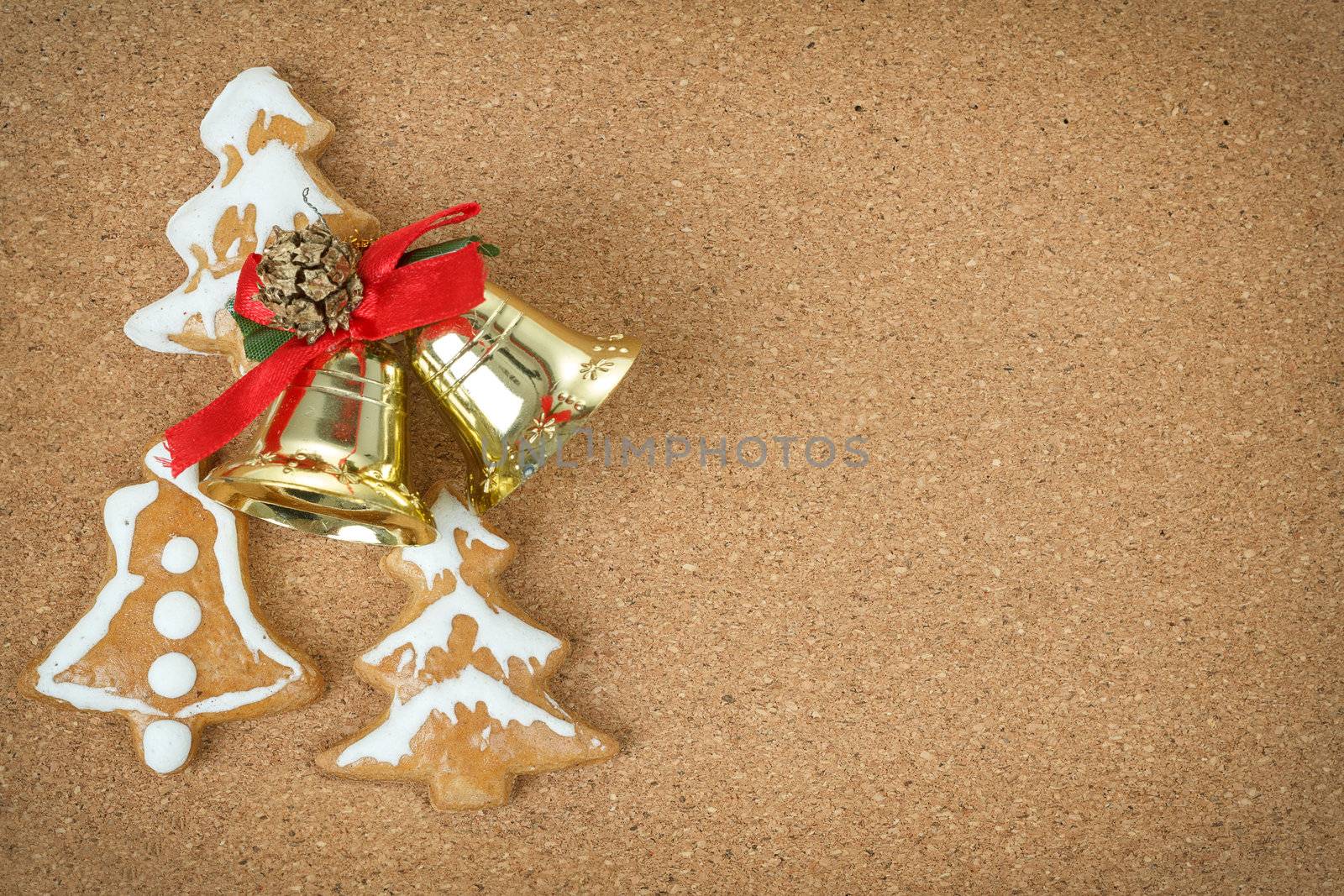 corc board with homemade ginger bread and christmas bells