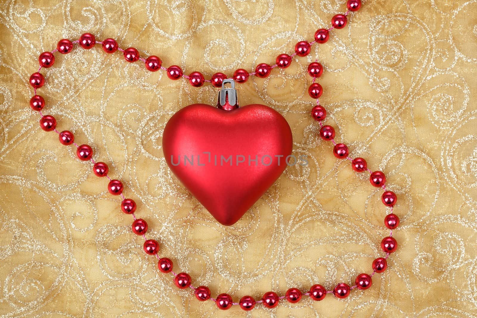red heart with jewelery on christmas table cloth