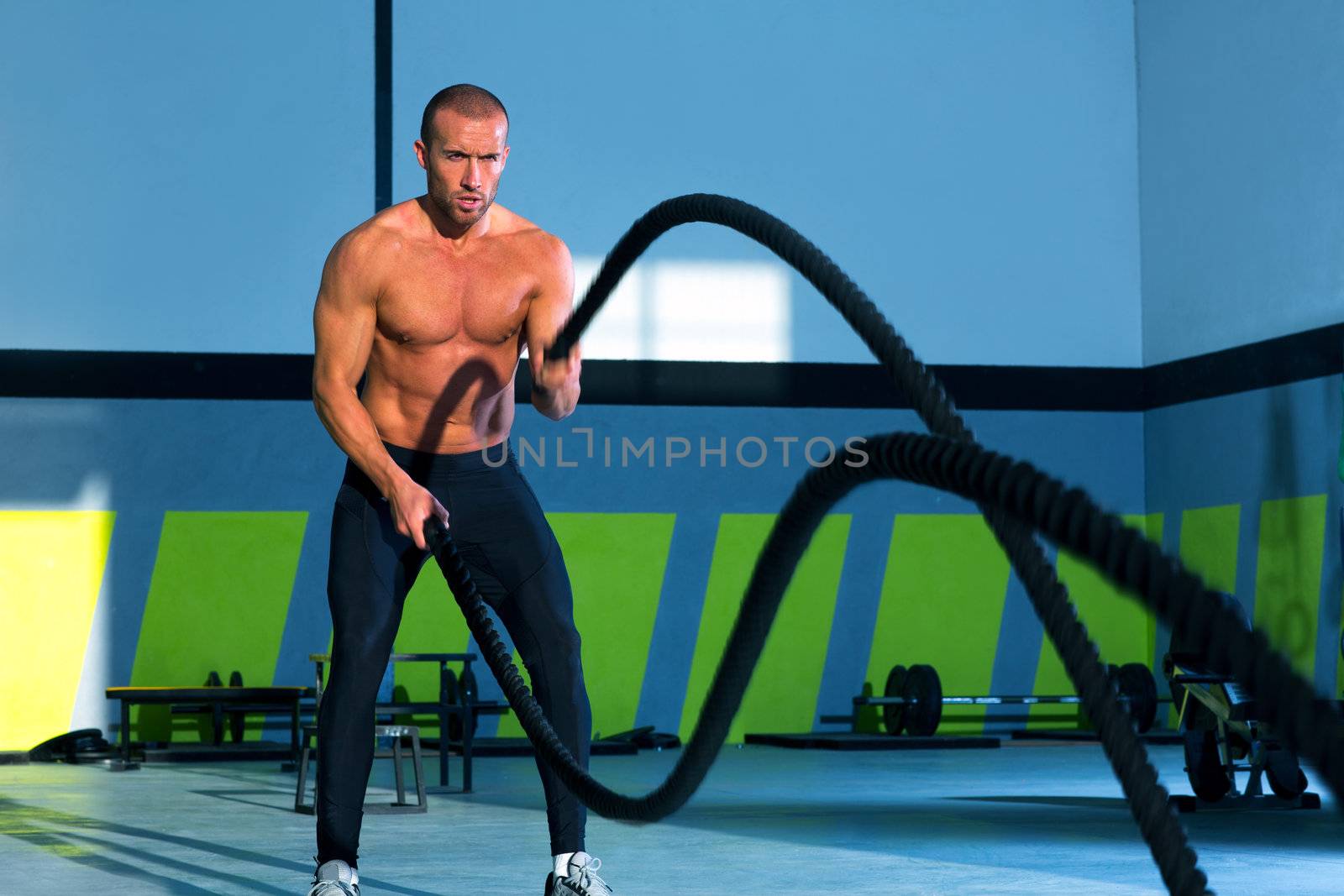 Crossfit battling ropes at gym workout exercise by lunamarina