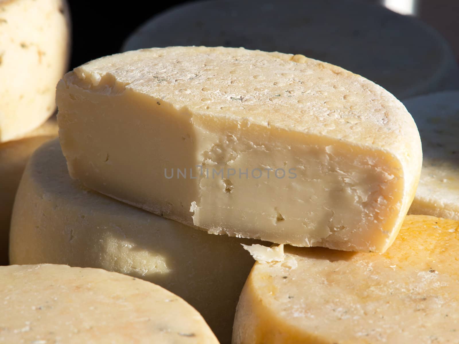 Different sorts of cheese at a market by nevenm