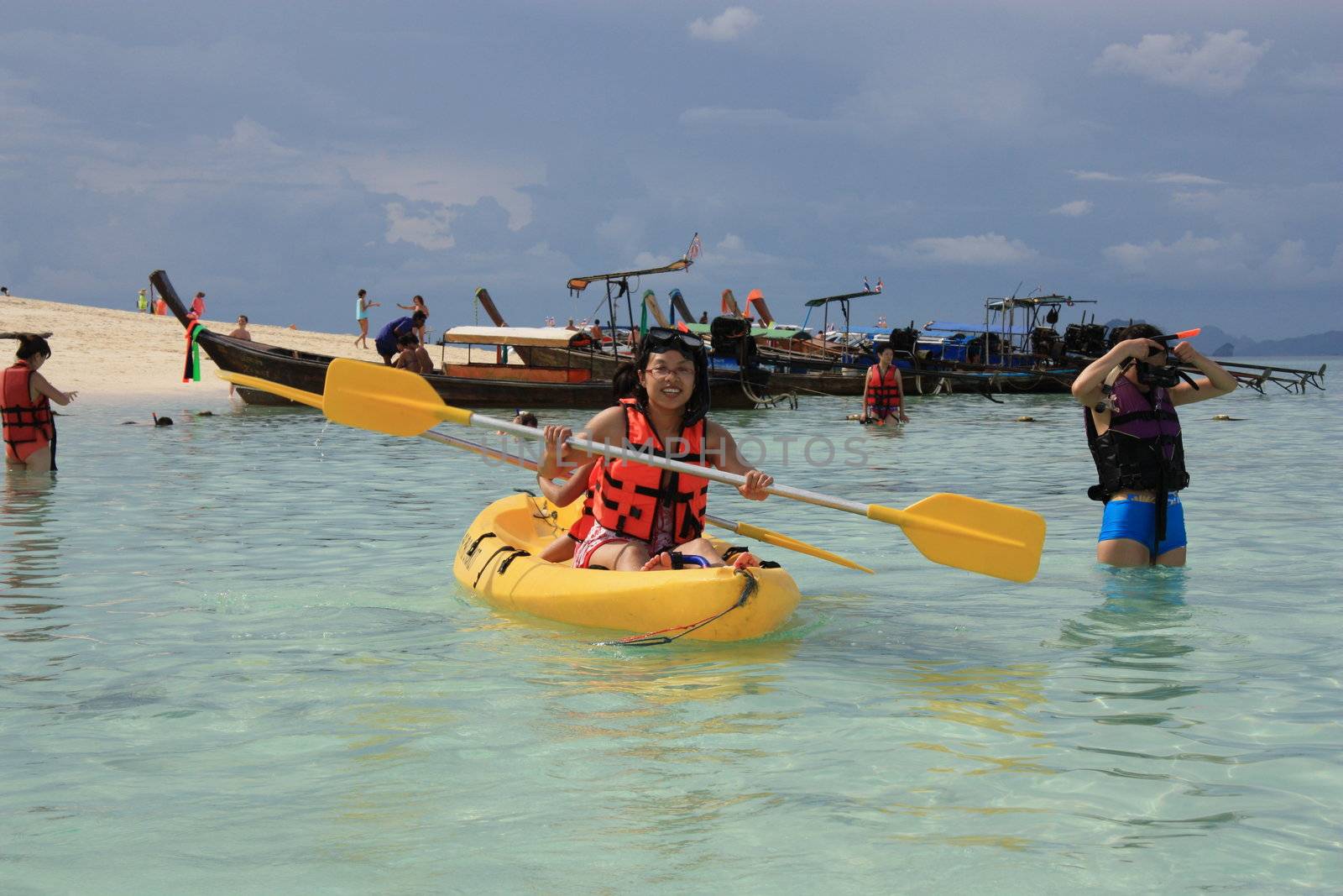 Happy People kayaking and snorkeling in a crystal water of Andaman sea, Thailand, Phi Phi island.