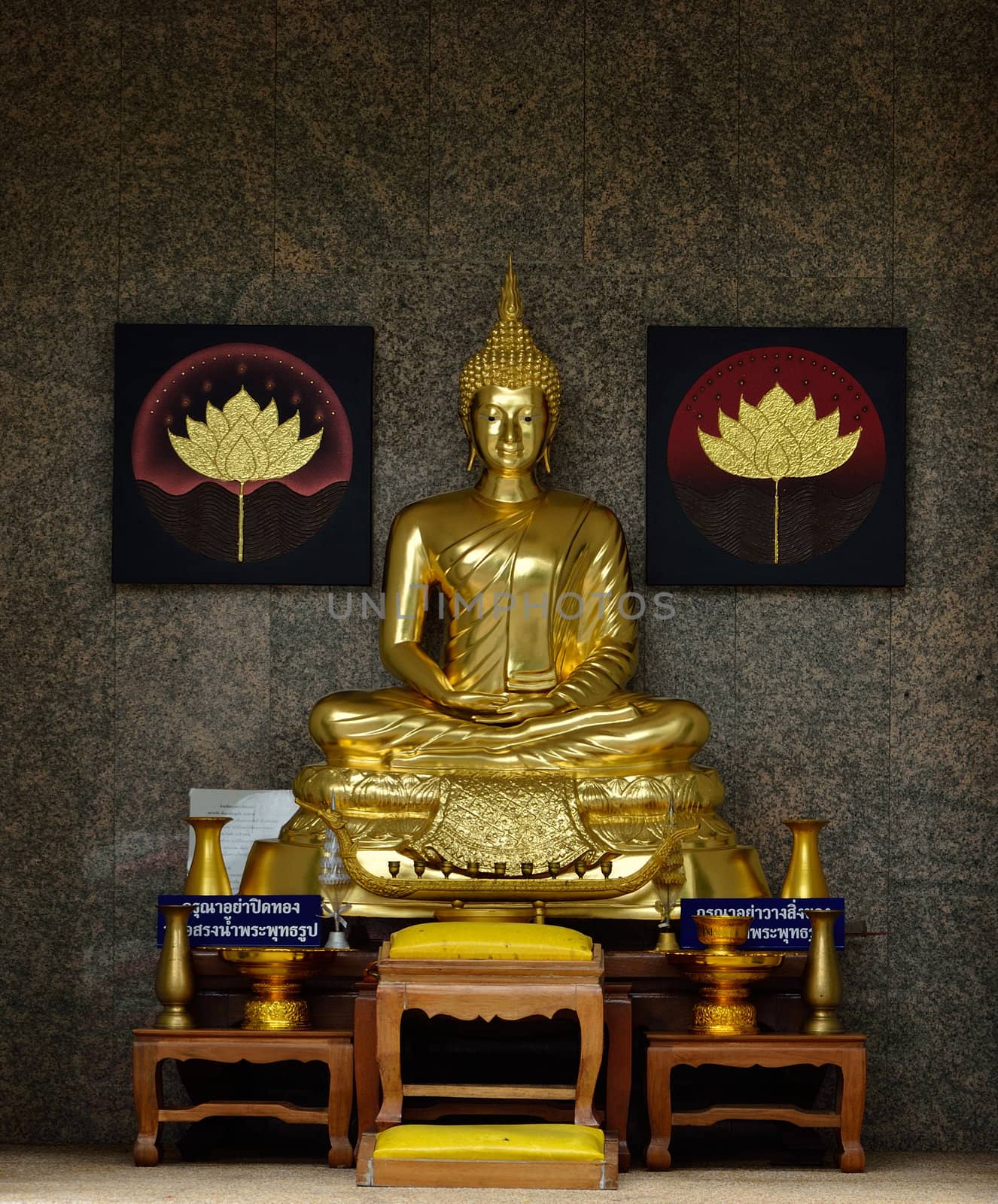 Golden Buddhist statue with table for worship